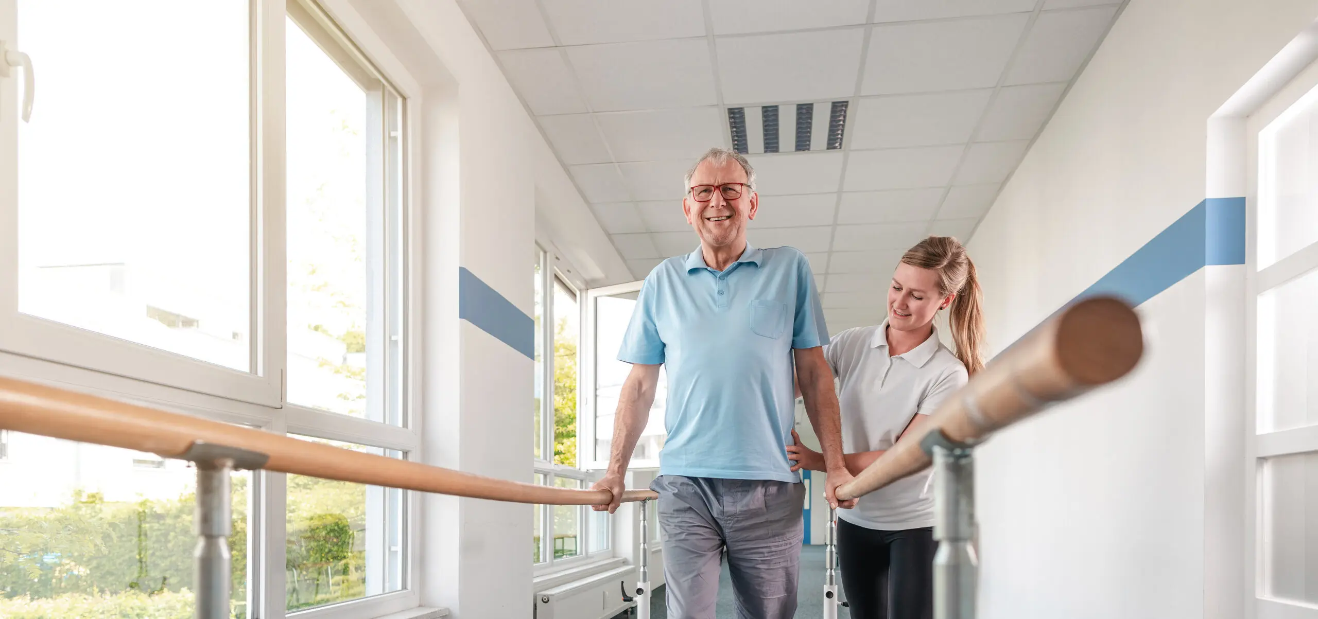 Senior Patient and physical therapist in rehabilitation walking exercises.